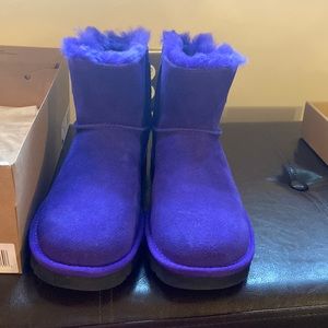Ugg purple boots with black soles.